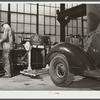 Repairing automobile motor. FSA (Farm Security Administration) warehouse depot. Atlanta, Georgia