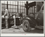 Repairing automobile motor. FSA (Farm Security Administration) warehouse depot. Atlanta, Georgia