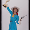 Susan Lucci holding an Emmy Award in a publicity photograph for Annie Get Your Gun