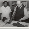 Nurse Shamburg and Dr. Dixon (R.E.) examining Susanna Pettway, whose father, Clement Pettway, has been ill for several years with tuberculosis. Gee's Bend, Alabama