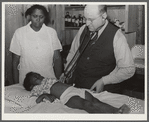 Nurse Shamburg and Dr. Dixon (R.E.) examining Susanna Pettway, whose father, Clement Pettway, has been ill for several years with tuberculosis. Gee's Bend, Alabama