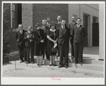 Group of speakers and guests with project manager Mr. Cathcart (at extreme left) on steps of auditorium after May Day-Health Day program at Ashwood Plantations, South Carolina