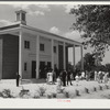 Project families, guests and schoolchildren leaving auditorium for picnic after May Day-Health Day program at Ashwood Plantations, South Carolina