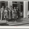 Group on steps of community auditorium with county doctor, project manager and nurse on May Day-Health Day program. Irwinville Farms, Georgia