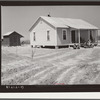 New home and smokehouse of Charles McGuire (tenant purchase borrower) with his wife and children on front porch. Pike County, Alabama