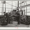 Repairing tractor. FSA (Farm Security Administration) warehouse depot. Atlanta, Georgia