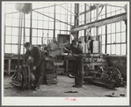 Repairing tractor. FSA (Farm Security Administration) warehouse depot. Atlanta, Georgia