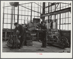 Repairing tractor. FSA (Farm Security Administration) warehouse depot. Atlanta, Georgia