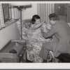 Doctor examining child in home. Greenbelt, Maryland