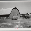 Stock barn with wagon and truck of hay on a very prosperous farm, over 600 acres, belonging to a Black farmer B.C. Corbett. This is a Black settlement. Near Carr, in Orange County, North Carolina