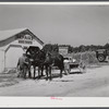 Combination filling station, garage, blacksmith shop, grocery store. Frank Petty, owner of the wagon, has just had his mule shod, his corn ground, purchases some kerosene and is returning home. R.F.D. Danville, Virginia, Pittsylvania County