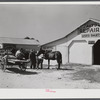 Combination filling station, garage, blacksmith shop, grocery store. Frank Petty, owner of the wagon, has just had his mule shod, his corn ground, purchases some kerosene and is returning home. R.F.D. Danville, Virginia, Pittsylvania County