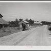 John D. Ferguson and son coming up road in wagon tobacco barns in the background. Route 57 going east from Chatham. But they live in settlement called Java, Virginia. Turn left at Baines filling station, again at store and it's a short distance to house