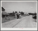 John D. Ferguson and son coming up road in wagon tobacco barns in the background. Route 57 going east from Chatham. But they live in settlement called Java, Virginia. Turn left at Baines filling station, again at store and it's a short distance to house