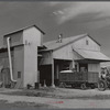 Modern gin and dryer with cotton brought in from fields by a tractor pulling large truck instead of smaller wagons. Truck holds eight bales of cotton. Hopson Plantation, near Clarksdale. Mississippi Delta, Mississippi