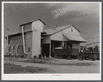 Modern gin and dryer with cotton brought in from fields by a tractor pulling large truck instead of smaller wagons. Truck holds eight bales of cotton. Hopson Plantation, near Clarksdale. Mississippi Delta, Mississippi