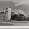Modern gin and dryer with cotton brought in from fields by a tractor pulling large truck instead of smaller wagons. Truck holds eight bales of cotton. Hopson Plantation, near Clarksdale. Mississippi Delta, Mississippi