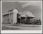 Modern gin and dryer with cotton brought in from fields by a tractor pulling large truck instead of smaller wagons. Truck holds eight bales of cotton. Hopson Plantation, near Clarksdale. Mississippi Delta, Mississippi