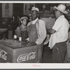 Mexican and Black cotton pickers inside plantation store, Knowlton Plantation, Perthshire, Mississippi Delta. This transient labor is contracted for and brought in from Texas each season