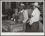 Mexican and Black cotton pickers inside plantation store, Knowlton Plantation, Perthshire, Mississippi Delta. This transient labor is contracted for and brought in from Texas each season