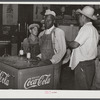Mexican and Black cotton pickers inside plantation store, Knowlton Plantation, Perthshire, Mississippi Delta. This transient labor is contracted for and brought in from Texas each season