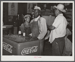 Mexican and Black cotton pickers inside plantation store, Knowlton Plantation, Perthshire, Mississippi Delta. This transient labor is contracted for and brought in from Texas each season