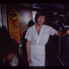 Restaurant worker in front of kitchen murals, Symposium Restaurant