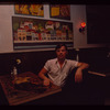 Restaurant worker seated at booth, Symposium Restaurant