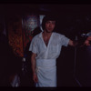 Restaurant worker in front of kitchen murals, Symposium Restaurant