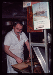 Restaurant worker cutting meat, Symposium Restaurant