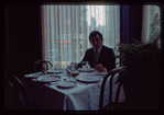 Man seated at dining table, 1057 Restaurant