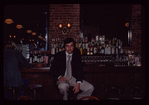 Man seated at bar, 1057 Restaurant