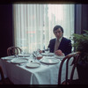 Man seated at dining table, 1057 Restaurant
