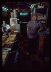 Restaurant worker in blue shirt at serving station, Nea Hellas
