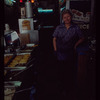 Restaurant worker in blue shirt at serving station, Nea Hellas