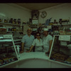 Three bakery workers behind counter, Poseidon