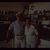 Two bakery workers in front of counter, Poseidon