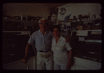 Two bakery workers in front of counter, Poseidon