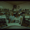 Three bakery workers behind counter, Poseidon