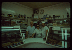 Three bakery workers behind counter, Poseidon