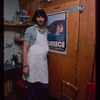 Grocer with grey shirt by poster, Grocer #2