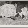 Very often farmers must travel long distances at night or wait several days for tobacco to be sold. They can be found sleeping on the covered piles of tobacco in warehouse or in their trucks or on the floors of camp room. Durham, North Carolina