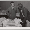 Black farmer who has brought his cotton samples to town discusses price with [white] cotton buyer. Clarksdale, Mississippi Delta, Mississippi