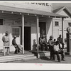 Black people cut each others' hair in front of plantation store after being paid off on Saturday. Mileston Plantation, Mississippi Delta