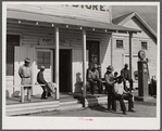 Black people cut each others' hair in front of plantation store after being paid off on Saturday. Mileston Plantation, Mississippi Delta