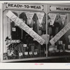 Signs on store window advertising sales during tobacco auction time in Zebulon. Wake County, North Carolina