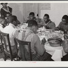 The Black tenants and neighbors eating dinner after the white men have finished on day of corn-shucking at Mrs. Fred Wilkins' home. Tallyho, Stem, Granville County, North Carolina