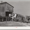 Joe Morgan, tenant on W.R. White farm, ready to leave the C.W. Lassiter gin with two bales of cotton on his wagon. Wake County, Wendell, North Carolina