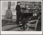 Mr. R.B. Whitley (in chair) visiting in his general store. He is president of the bank and practically owns and runs the town. He is a big landowner, owns Whitley-Davis farm and a cotton mill in Clayton. He said he cut down the trees and pulled up the