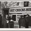 Farmers getting their checks in warehouse office after their tobacco has been sold at auction. Durham, North Carolina